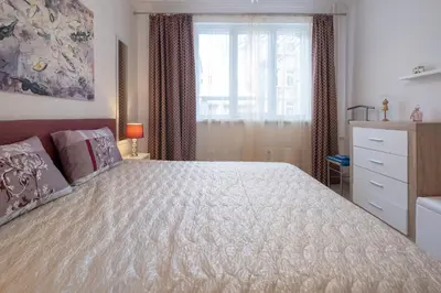 a bedroom with a large bed and a window at Two Bedroom Apartment Near to Doctors Garden in Sofia