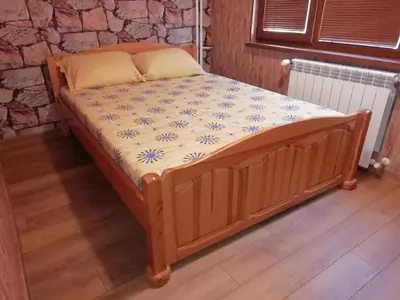 a wooden bed in a room with at Apartment Lagera 55 in Sofia