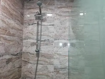 a shower with a glass door in a bathroom at Apartment Lagera 55 in Sofia