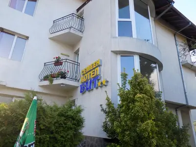 a sign on the side of a building at Семеен Хотел Вит in Teteven