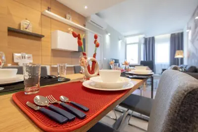a table with a red tray with utensils on it at Vitosha Blvd Luxury 2-Bedroom, 2-Bathroom with Balcony in Sofia