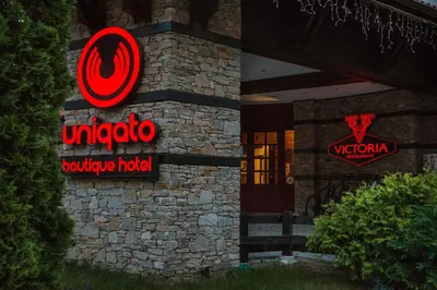 a hotel sign on the side of a building at Boutique Hotel Uniqato in Bansko