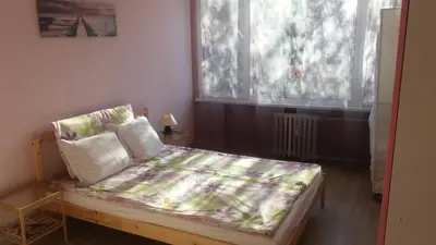 a small bedroom with a bed with a blanket on it at Cosy place close to the Center in Sofia