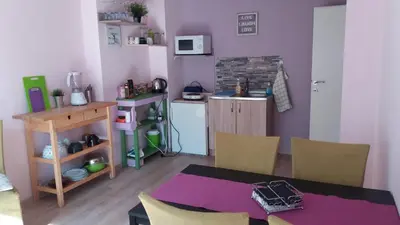 a kitchen with a table and chairs in a room at Cosy place close to the Center in Sofia