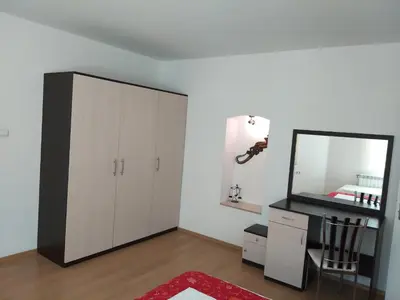 a bedroom with a mirror and a white cabinet at ХОТЕЛ НИК in Asenovgrad