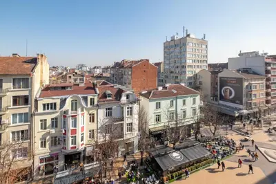 a group of people walking around a city with buildings at Vitosha Blvd 3-Bedroom, 2-Bathroom Lux Suite in Sofia
