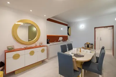 a dining room with a table and a mirror at Vitosha Blvd 3-Bedroom, 2-Bathroom Lux Suite in Sofia