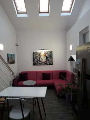 a red couch in a living room with skylights at Red House in Kyustendil