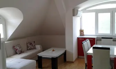 a living room with a couch and a table at Apartment Sagittarius in Kyustendil