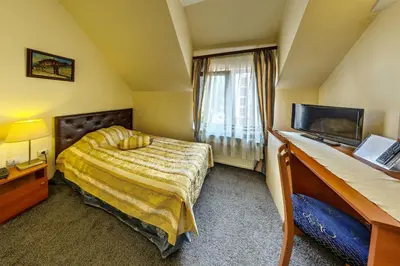 a hotel room with a bed and a television at Hotel Cheap - Smart choice - Great value in Sofia