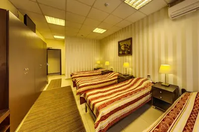 a row of four beds in a room at Hotel Cheap - Smart choice - Great value in Sofia