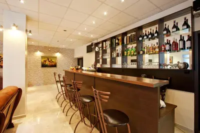 a bar with a bunch of bottles of wine at Hotel Cheap - Smart choice - Great value in Sofia