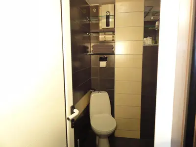 a small bathroom with a toilet in a stall at Apartment SOFIA LUX TOP CENTER in Sofia