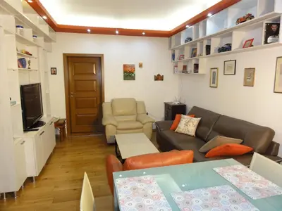 a living room with a couch and a tv at Apartment SOFIA LUX TOP CENTER in Sofia