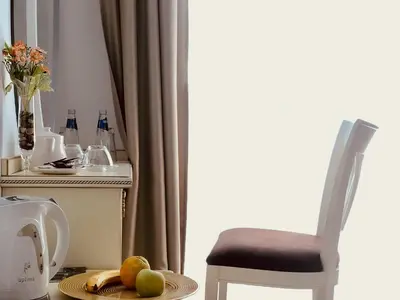 a chair and a plate of fruit on a table at ATLAS HOUSE Luxury Suites in Plovdiv