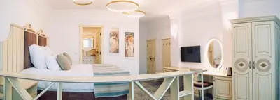 a bedroom with a bed and a desk in a room at ATLAS HOUSE Luxury Suites in Plovdiv