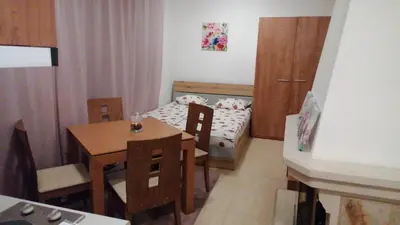 a small room with a table and a small bedroom at Grand Monastery - Studio Rossa in Pamporovo