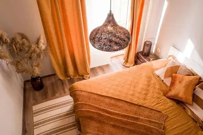 a bedroom with a bed and a window at Baba Taki Apartment in Plovdiv