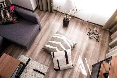 a living room with a couch and a rug on a wooden floor at Baba Taki Apartment in Plovdiv