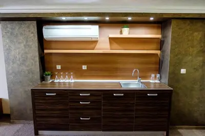 a kitchen with a sink and a microwave at Hotel Elit in Pernik