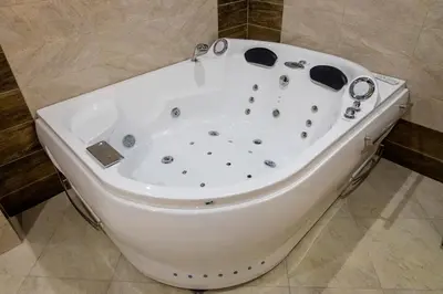 a white bath tub sitting in a bathroom at Hotel Elit in Pernik