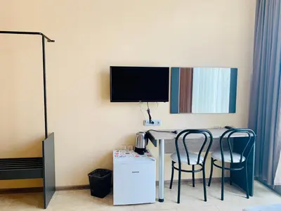 a room with a table with two chairs and a tv at Agora Studios in Plovdiv