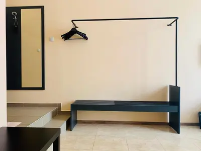 a dressing room with a blue bench and a mirror at Agora Studios in Plovdiv
