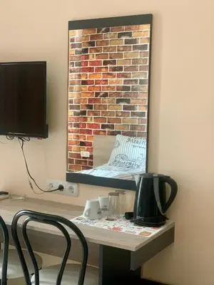 a mirror hanging on a wall next to a table at Agora Studios in Plovdiv