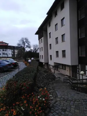 a building with a bunch of flowers in front of it at the old inn in Bansko