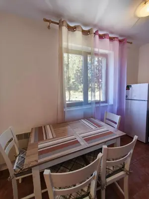 a dining room table with chairs and a window at the old inn in Bansko