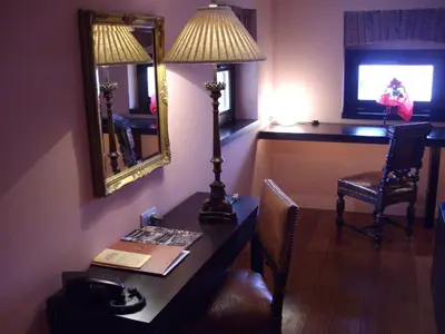 a room with a desk with a lamp and a mirror at Kokoshkovata Boutique House in Samokov