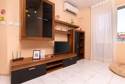 a living room with a flat screen tv on a wall at Roof top terrace maisonette in Plovdiv