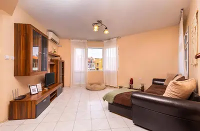 a living room with a couch and a television at Roof top terrace maisonette in Plovdiv