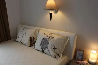 a room with a bed with two pillows and a lamp at Hotel39 in Plovdiv