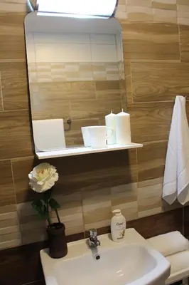 a bathroom with a sink and a mirror at Hotel39 in Plovdiv