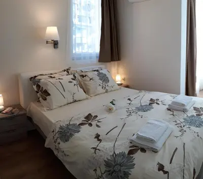 a bedroom with a bed with a floral bedspread at Hotel39 in Plovdiv
