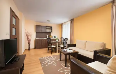 a living room with a couch and a table at Apartments Bansko in Bansko