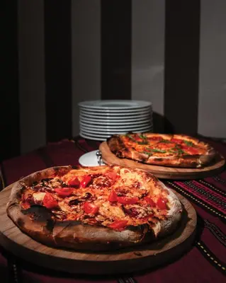 two pizzas sitting on top of a table at Apartments Bansko in Bansko