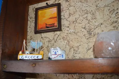 a wooden shelf with a painting on a wall at Mansard Art Studio - Central Sofia in Sofia