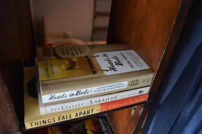 a stack of books sitting on top of a shelf at Mansard Art Studio - Central Sofia in Sofia