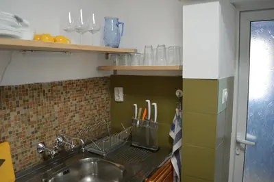 a kitchen with a sink and a counter with utensils at Mansard Art Studio - Central Sofia in Sofia