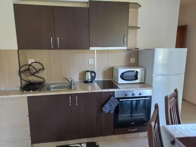 a kitchen with a white refrigerator and a microwave at Ski & Holiday Apartments in Pamporovo in Pamporovo