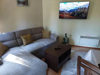 a living room with a couch and a table at Ski & Holiday Apartments in Pamporovo in Pamporovo