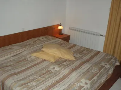 a bed with two pillows on top of it at Saint George Holiday Village in Borovets