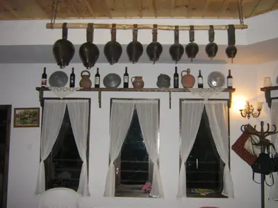 a kitchen with a shelf with pots and pans on the wall at комплекс ВОДОПАДА in Plovdiv