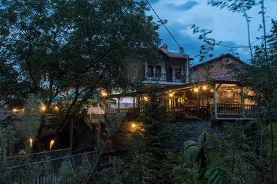 a house lit up at night with lights at комплекс ВОДОПАДА in Plovdiv