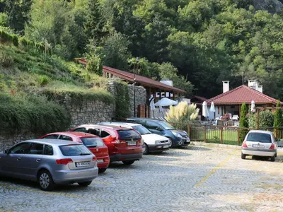 a row of cars parked in a parking lot at Хотел Аква Варвара in Varvara