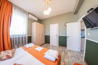 a bedroom with a bed with two towels on it at Sofia Vintage Life Apartment in Sofia