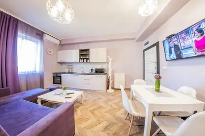 a living room with a couch and a table at Sofia Violet Life Apartment in Sofia