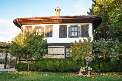 an old house with a roof with fruit in the yard at Djudjeva Kyshta Hotel in Panagyurishte